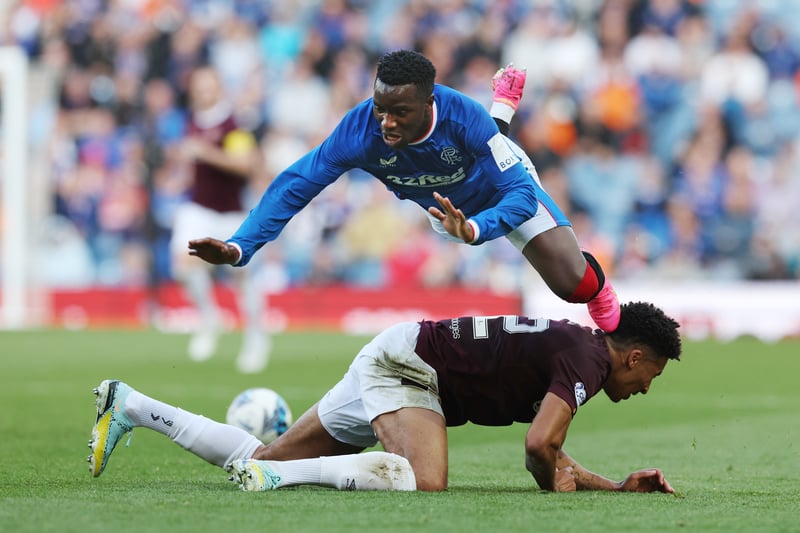 Fashion Sakala of Rangers is sent flying after a challenge from Jambos defender James Hill.