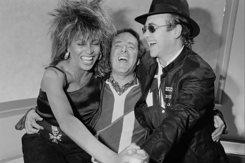 Tina Turner and Elton John with chat show host Terry Wogan at the BBC Television Centre in Shepherd’s Bush on February 18, 1985. (Photo by Steve Wood/Express/Hulton Archive/Getty Images)