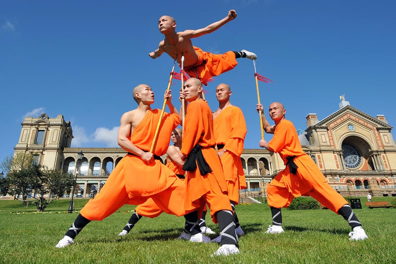 Shaolin Wu-Shu Warriors balancing one of the performers on spears. Credit: Leon Neal/AFP via Getty Images.