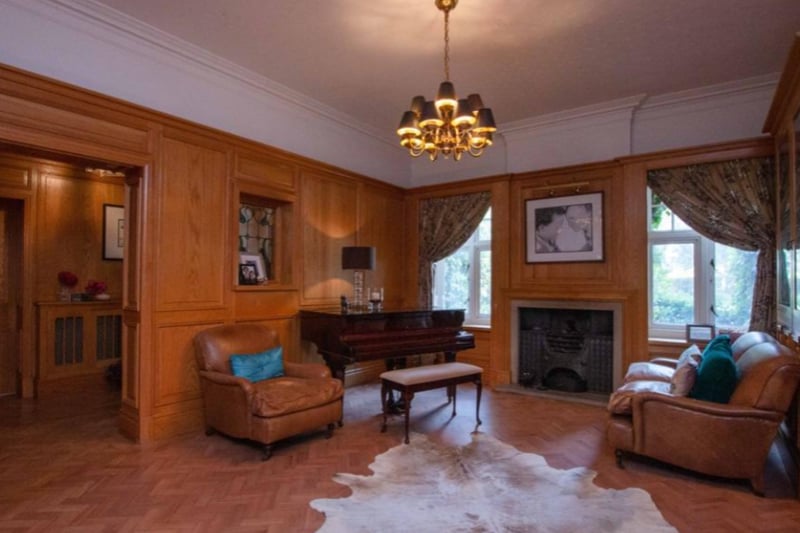 The grand home has a wood panelled reception hall with parquet flooring and feature fireplace.