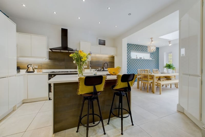 The kitchen has a small island in the centre of the room with space for bar stools, making it perfect for entertaining