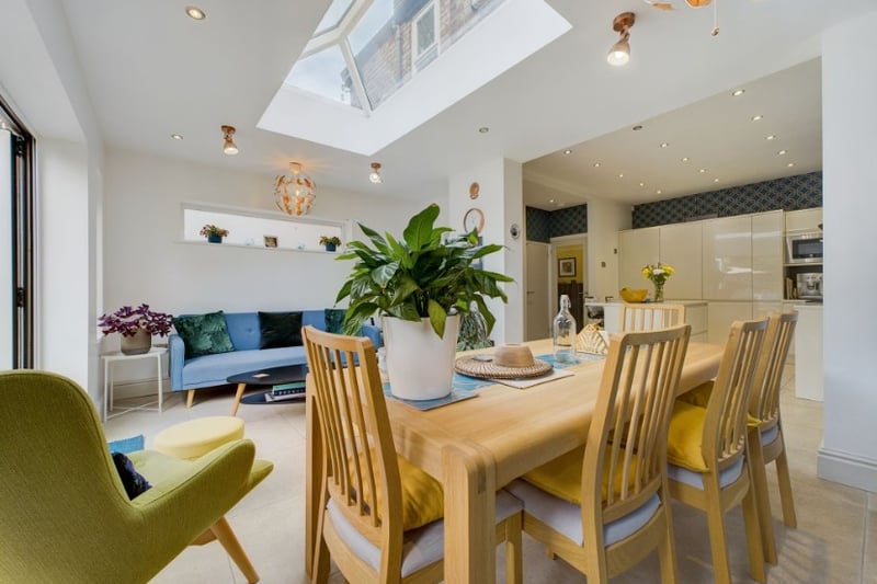 The dining room benefits from lots of natural light from the large french doors and sky light