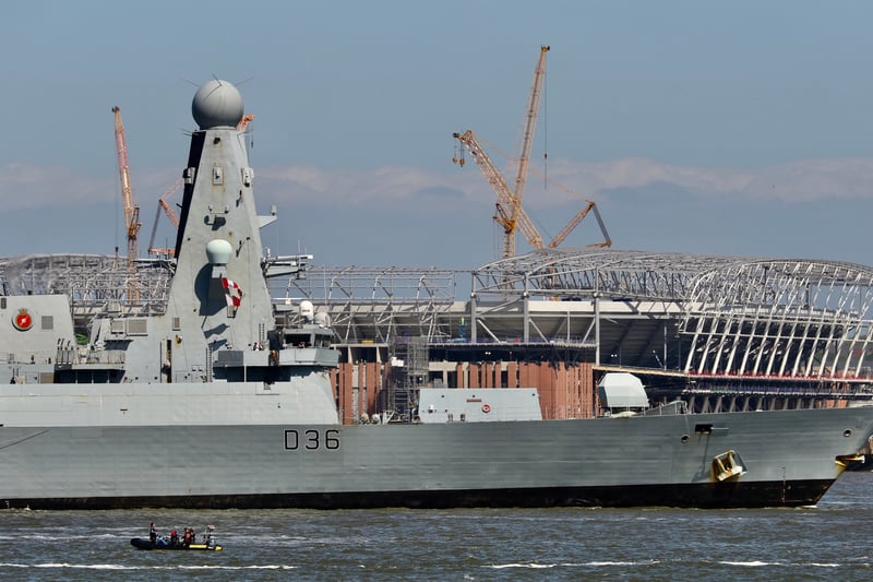 Type 45 Destroyer HMS Defender sails past Everton’s new stadium at Bramley-Moore Dock.