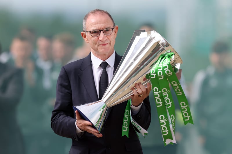 Former Celtic manager Martin O’Neill carries the Premiership trophy and leads the Scottish champions towards the stadium. 