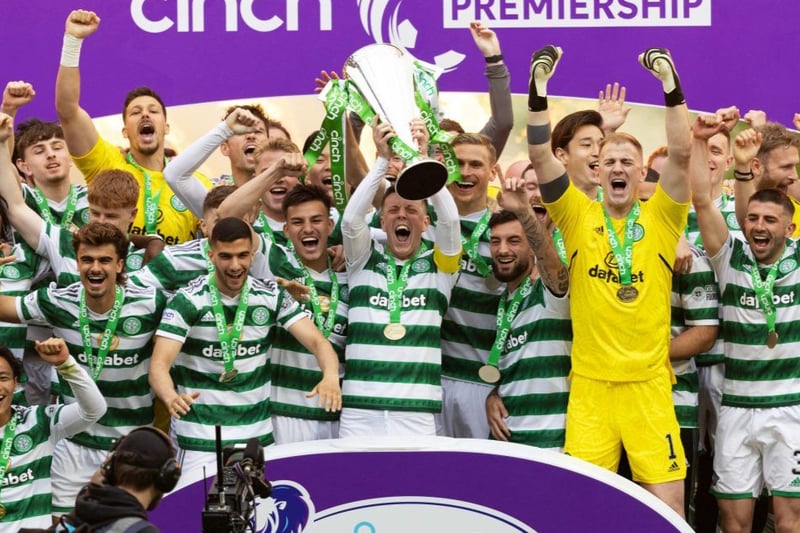 Hoops skipper Callum McGregor holds the Scottish Premiership trophy aloft surrounded by team mates.