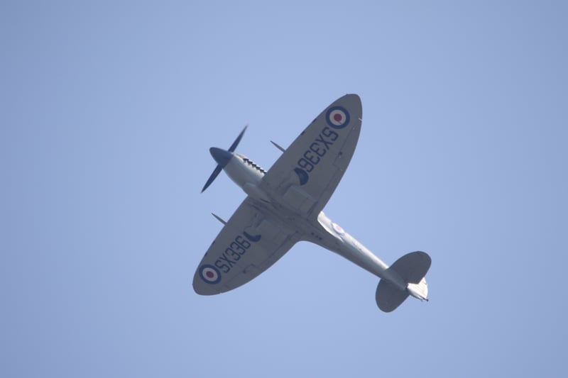 One of the iconic Battle of Britain Memorial Flight planes flies overhead. 