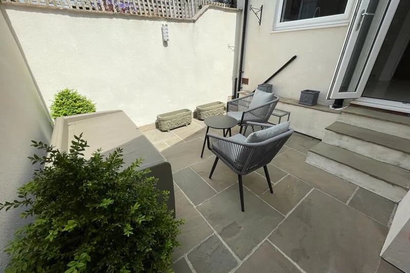 “Stepping outside into the south-facing courtyard garden, you are met with an oasis of tranquility. The Indian stone paving underfoot exudes an air of sophistication and provides the perfect setting for outdoor dining and entertaining.”
