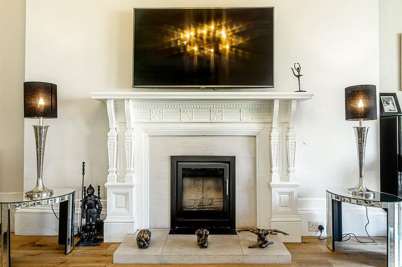 The focal point of the sitting room is the fireplace with living flame gas fire. 