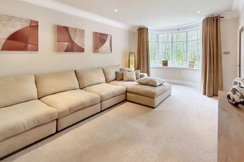 The living room is incredibly spacious with a gorgeous bay window
