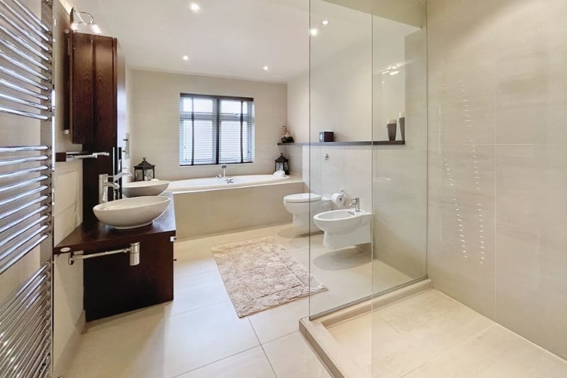 The family bathroom is a large size with a huge bath and walk in shower