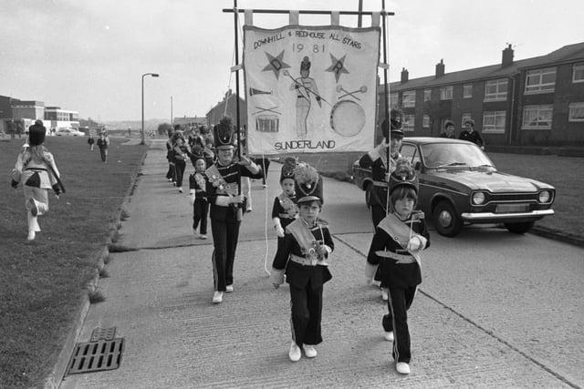 Spot of music anyone? It's the Downhill and Redhouse All Stars jazz band marching through the streets of Downhill towards the Carnival ground in 1982.