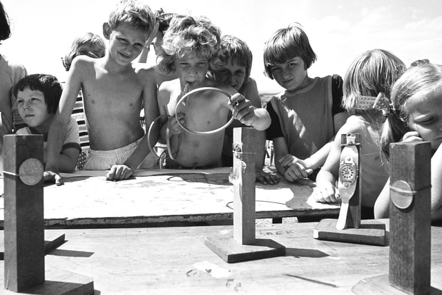 Look at the concentration on the faces of these children as they try to win a prize at Penshaw Carnival in 1976.