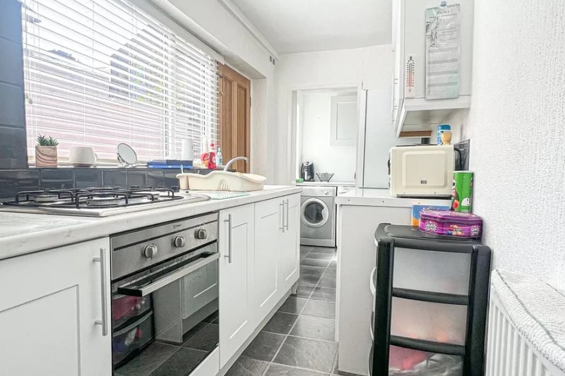 The kitchen is small but has a seperate utility room for additional storage space