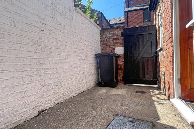 The property has a small concrete yard to the rear of the home