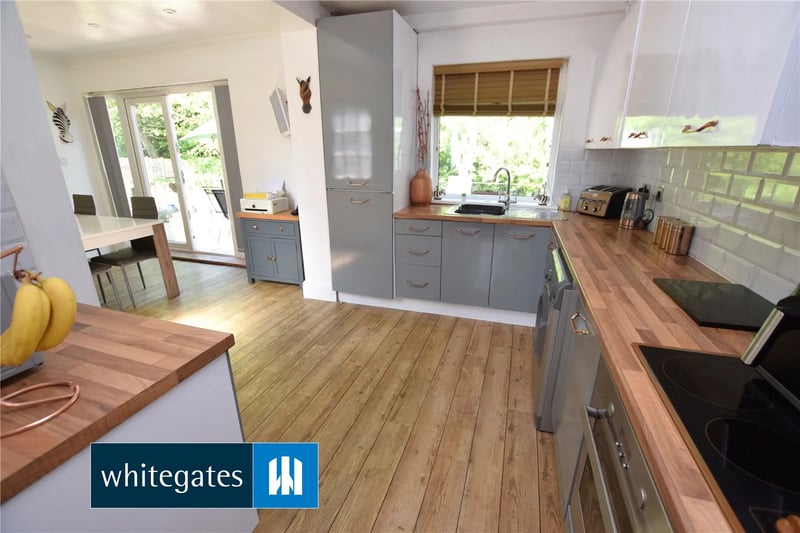 The spacious kitchen has a built in oven with electric hob, a single drainer sink with mixer tap and integrated fridge freezer and dishwasher.