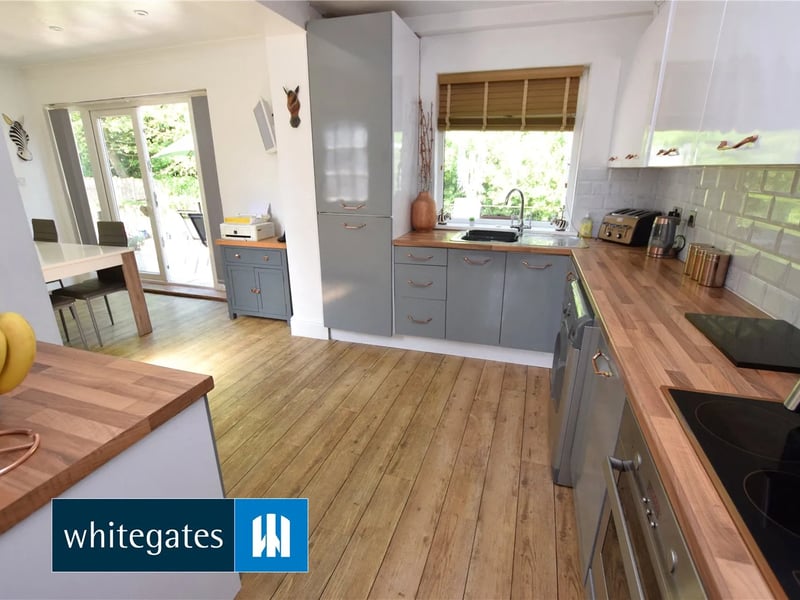 The spacious kitchen has a built in oven with electric hob, a single drainer sink with mixer tap and integrated fridge freezer and dishwasher.
