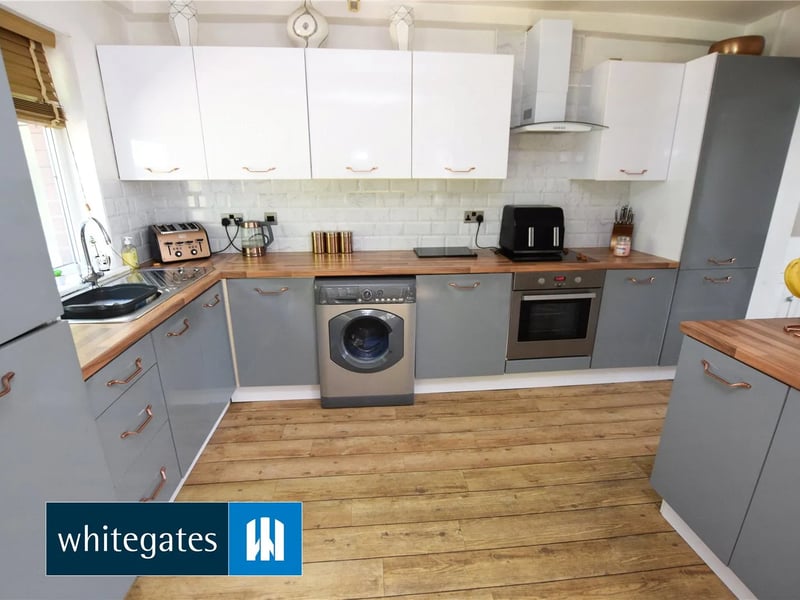 The spacious dining kitchen is an open plan extension with a range of base and wall units.