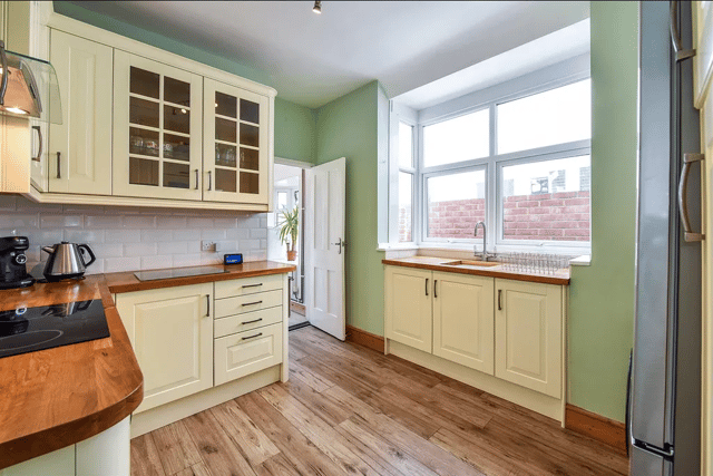 A stylish kitchen is fitted in the property with a large window over the sink
