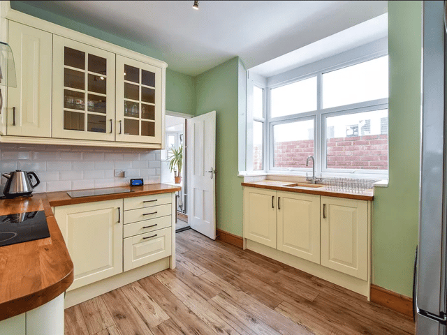 A stylish kitchen is fitted in the property with a large window over the sink