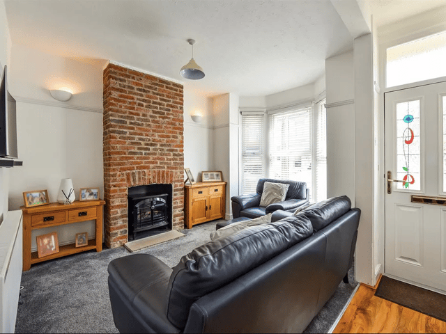 The entrance leads into the living room area which has its own fireplace