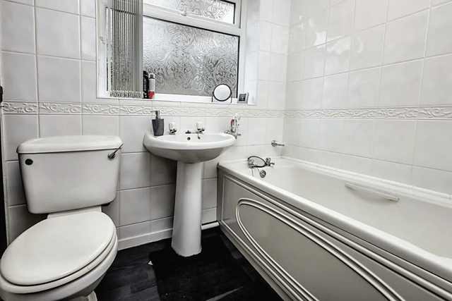 The bathroom has modern features but maintains the classic theme throughout