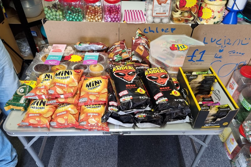 Classic beef Space Raiders and cheese Mini Cheddars sit on a table in front of the till. Cakes have also recently been added to the display.