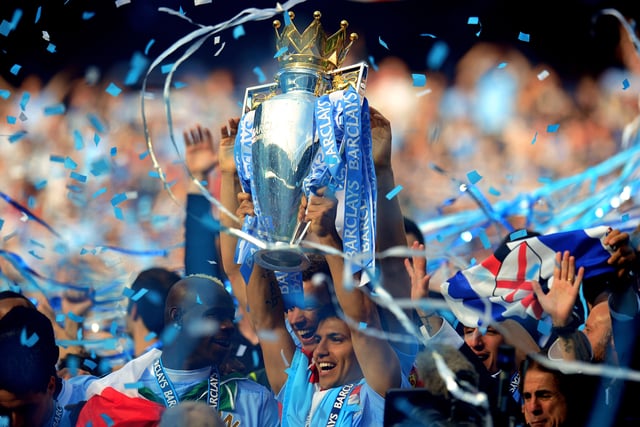Sergio Aguero lifts the Premier League trophy following Man City's dramatic 3-2 win against QPR in May 2012