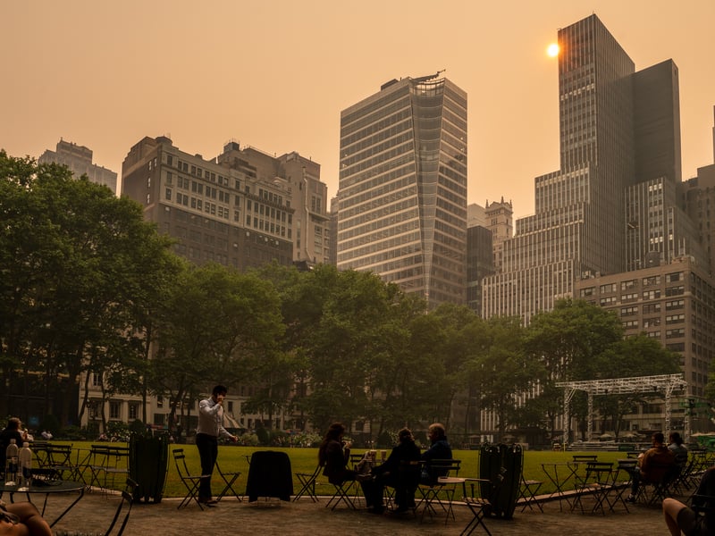 People sit in Bryant Park in central Manhattan. (Photo by David Dee Delgado/Getty Images)
