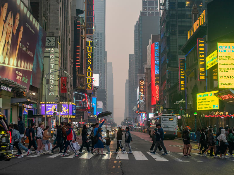 People continue their business and make their way around Times Square. (Photo by Eduardo Munoz Alvarez/Getty Images)