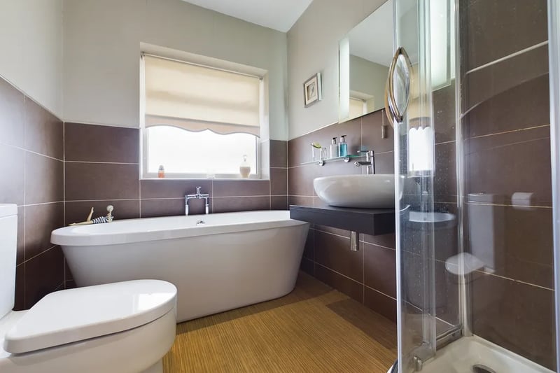 Oene of the property’s beautiful three bathrooms, featuring a gorgeous free-standing bath and separate shower.