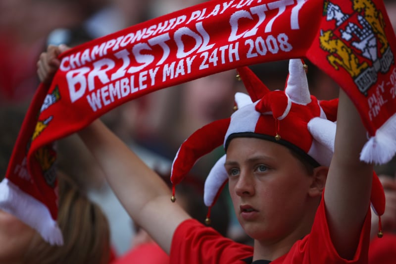 A Bristol City fan wearing a jester hat - holds up his scarf ahead of the Championship play-off. Does he still have that momento of a painful day? 