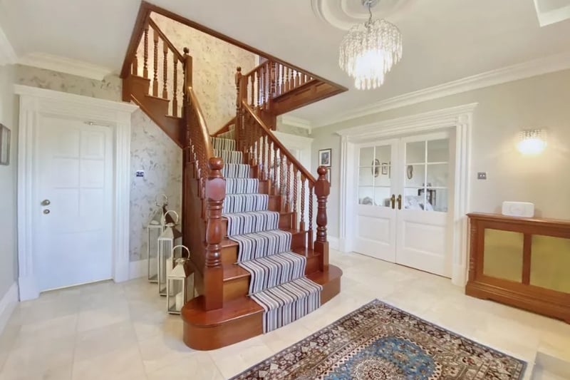 The entrance hall has a beautiful wooden staircase