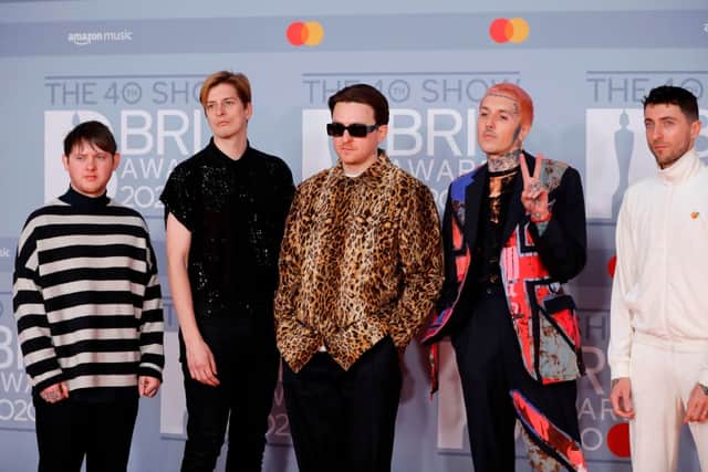 Bring Me The Horizon, pictured here at the BRIT Awards in 2020, has announced it has parted ways with keyboardist Jordan Fish (right). Photo by Getty Images.