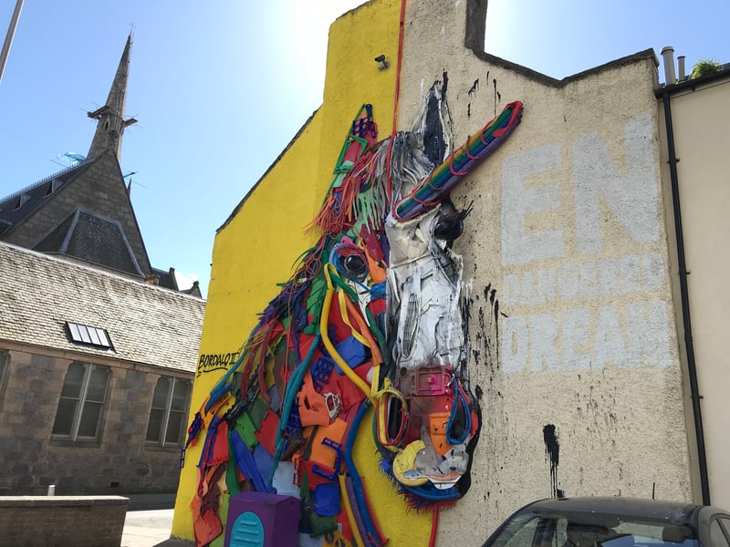 Depicting Scotland’s national animal the unicorn, Bordalo II created his 2018 Nuart masterpiece using rubbish. The Portuguese duo used waste from plastic pipes to car parts to construct their sculpture, which is located on Union Row. Look for Italian restaurant Rustico and you should easily spot this wonder. 