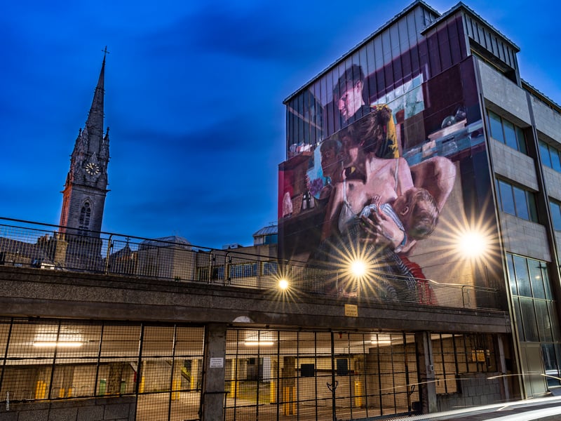 Having taken part in the 2019 Nuart festival, Helen Bur’s first Aberdeen murals were removed when the building used as a canvas was destroyed. The London-based artist didn’t let that deter her however, and returned triumphantly for the 2021 festival. Creating a connection to her first project, her second mural also showcases couple Hugo and Ally but this time as a family unit, with Ally breastfeeding newborn baby Ruby-Rae. Painted during World Breastfeeding Week, Bur’s art and narrative portrays stories of love, and is another which can be found on Union Wynd, just across from Union Plaza.