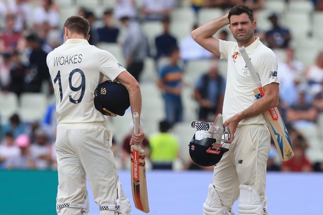 England's Chris Woakes (L) and England's James Anderson (R) prepare to leave the field after England are bowled out on the fifth day of the first Ashes cricket Test match between England and Australia at Edgbaston