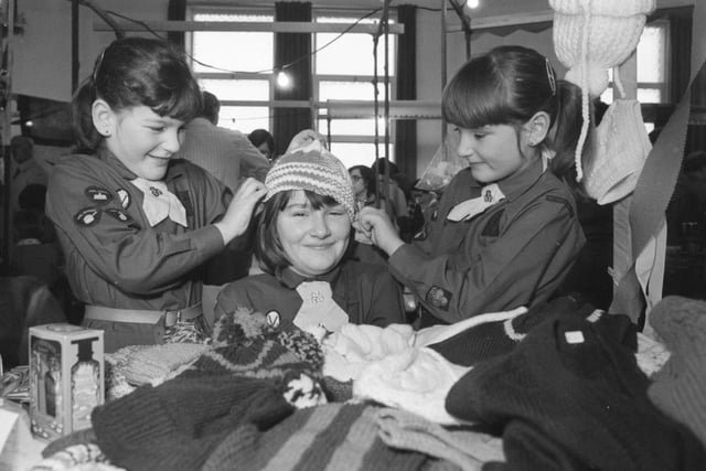 The 41st Sunderland Salvation Army brownies held a 'sale of the century' event in 1982. 
Here are twins Debra, left, and Diane Sharp trying out a hat which was for sale on older sister Pauline.