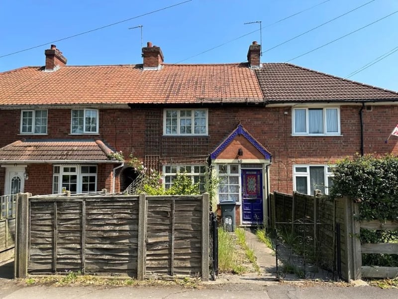 The front of the property shows a small front garden