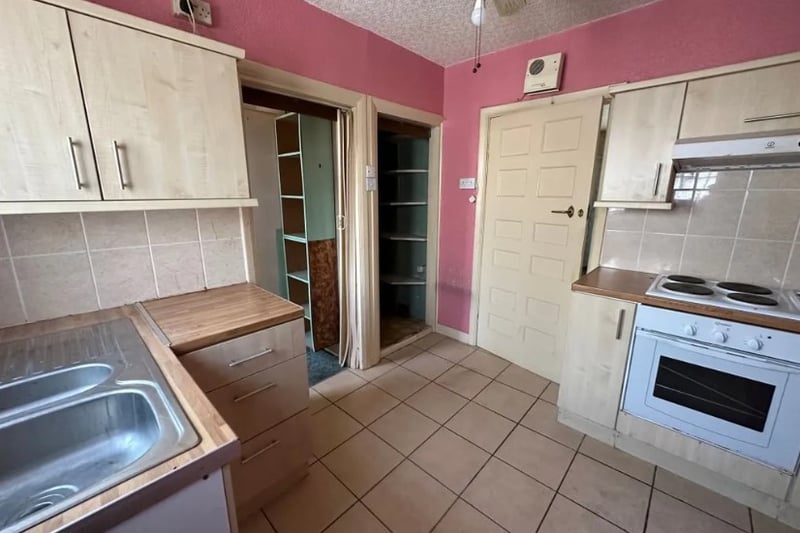 The kitchen is a nice size but could use a bit of refurbishment