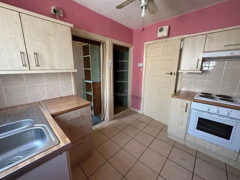 The kitchen is a nice size but could use a bit of refurbishment