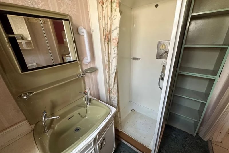 There is a small downstairs bathroom with a small shower