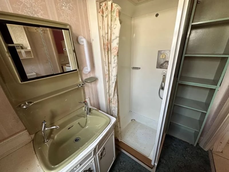 There is a small downstairs bathroom with a small shower