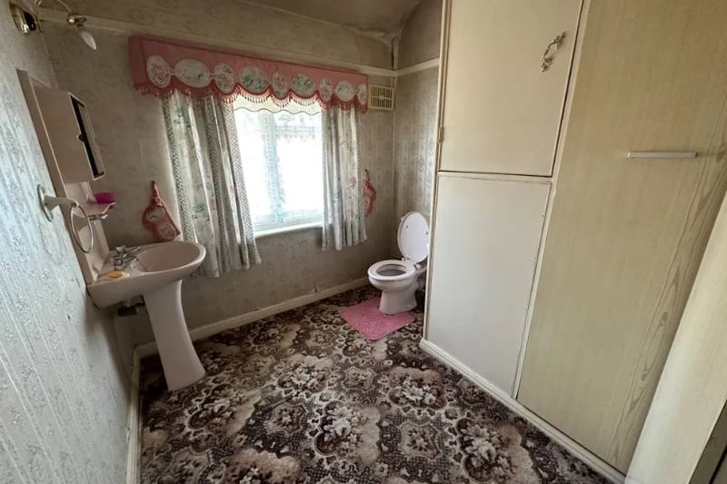 The bathroom is a good size but could use some work to make it modern