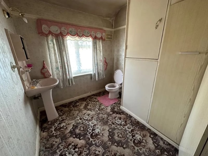 The bathroom is a good size but could use some work to make it modern