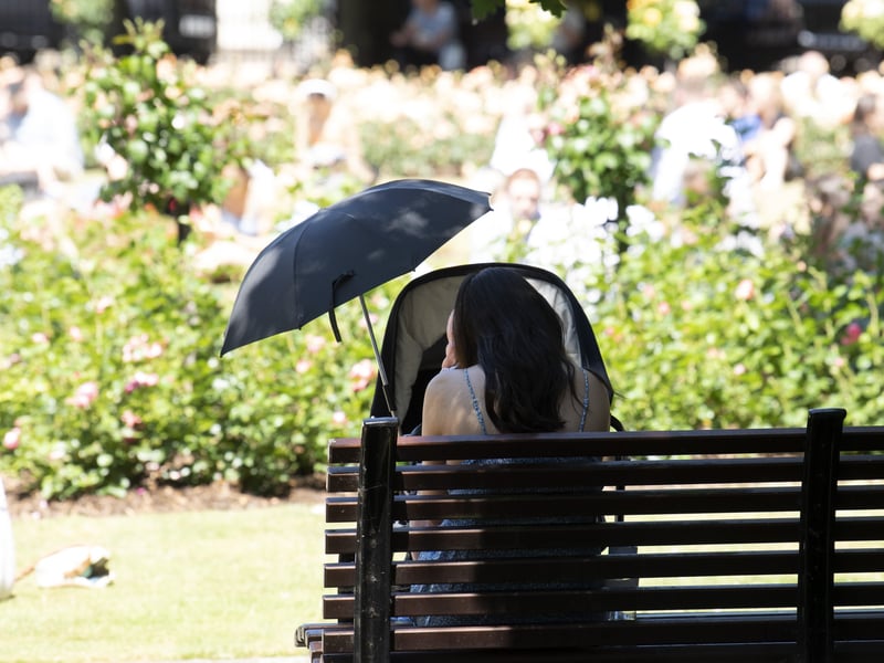 A mother made sure to keep her baby in the shade.