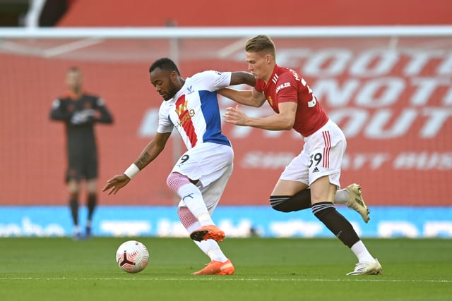 Jordan Ayew of Crystal Palace battles for possession with Scott McTominay of Manchester United during the Premier League match between Manchester United and Crystal Palace at Old Trafford on September 19, 2020