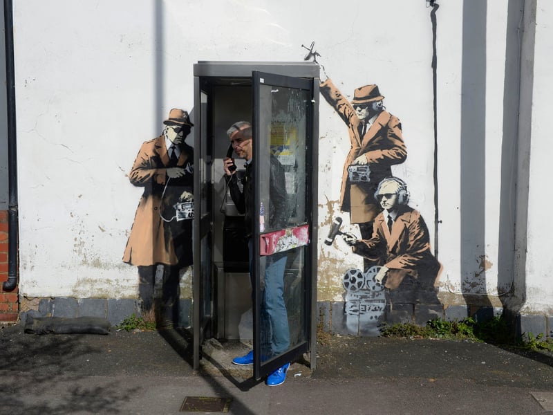 First spotted in Cheltenham, England, ‘Spy Booth’ shows three government noir-style spies who are perched around a telephone booth using 1950s surveillance equipment to eavesdrop on the user’s conversation within. The art was reportedly in close proximity to the Government Communications Headquarters (GCHQ) which is tasked with sending information to the British Government and Armed Forces.