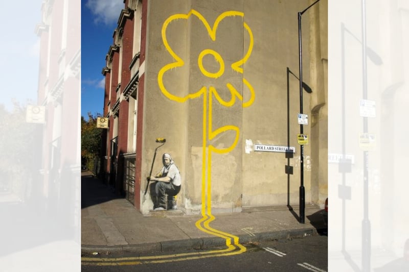 Considered one of his most famous works, it first appeared in Benthal Green in London. It was painted on the side of a working man’s club and it depicts a painter in overalls who is tasked with painting yellow lines along the road. However, he has instead taken a break and has painted yellow lines up the wall that form a huge yellow flower (a message of positivity and hope amid the tedium of work, perhaps?)
