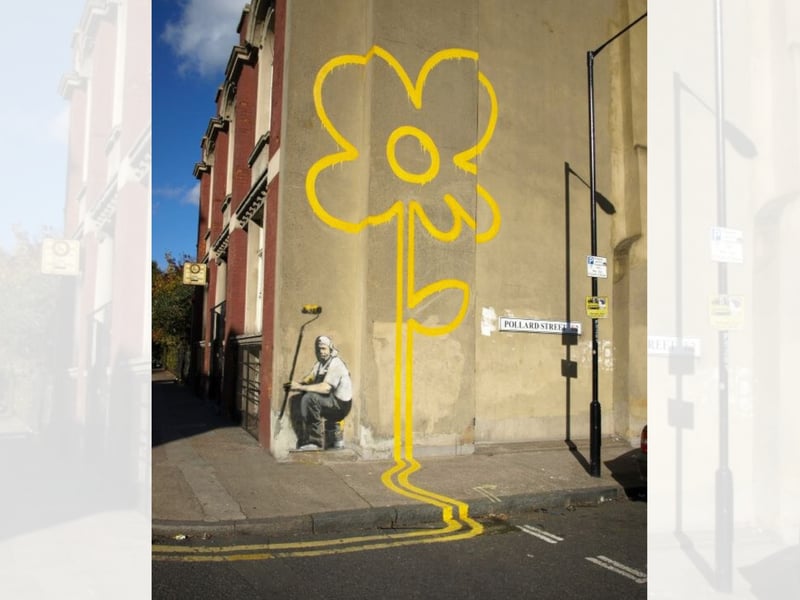 Considered one of his most famous works, it first appeared in Benthal Green in London. It was painted on the side of a working man’s club and it depicts a painter in overalls who is tasked with painting yellow lines along the road. However, he has instead taken a break and has painted yellow lines up the wall that form a huge yellow flower (a message of positivity and hope amid the tedium of work, perhaps?)