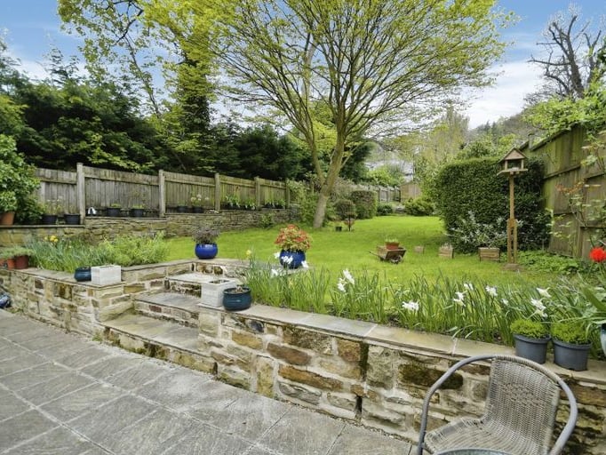 The garden has a paved patio area and plenty of lawn.